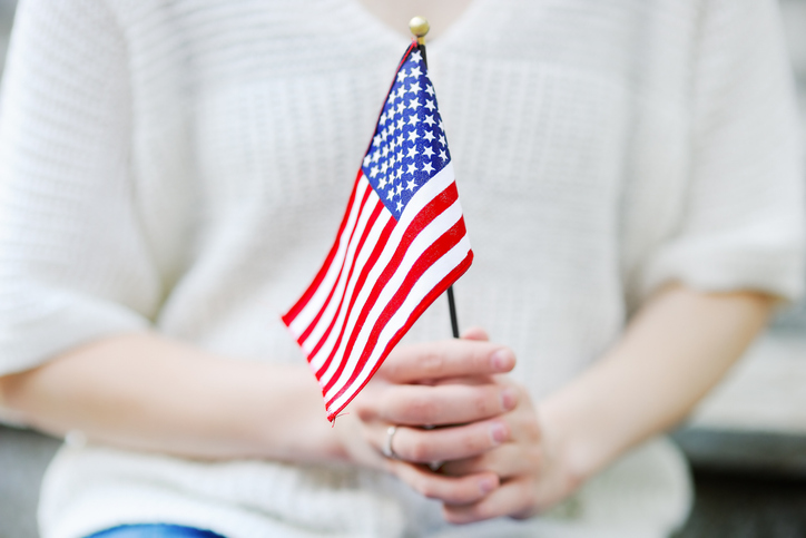 woman holding a U.S. small flag